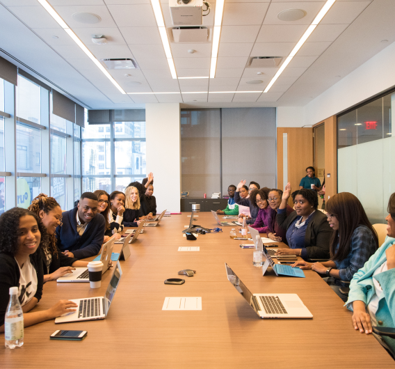 Group In Conf Room With Laptops